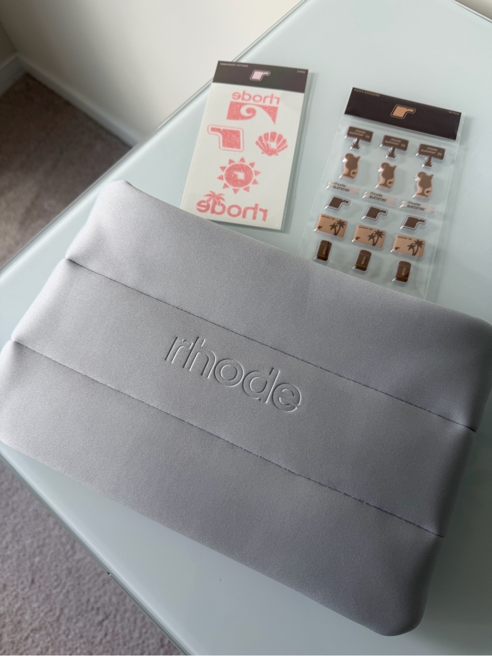 RHODE Gray bubble makeup bag with tattoos and stickers